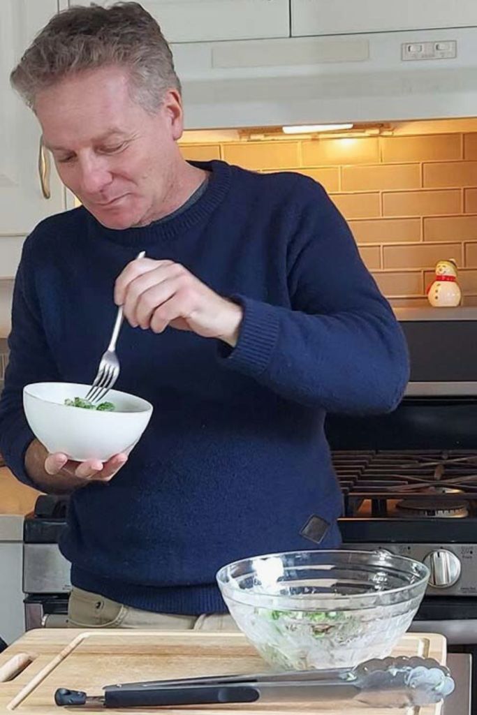 Digging a fork into broccoli salad.