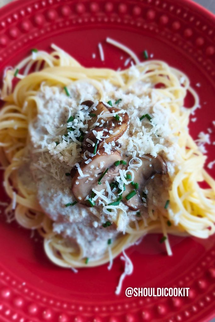 Cooked pasta with mushroom wine sauce, mushrooms and chives